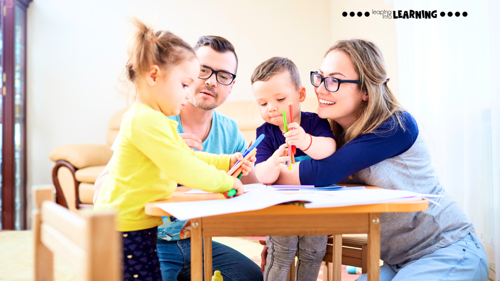 Family sitting together at a table doing a colorful preschool learning activity.